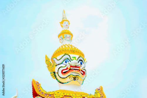 Photography White Giant Architectural Protector Wat Arun on blue sky.
