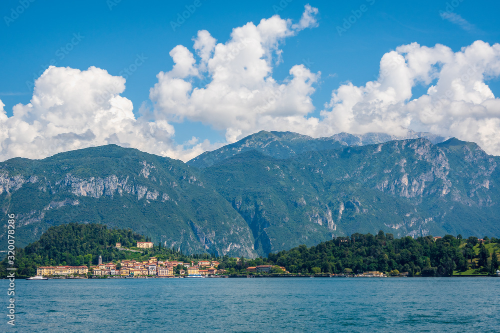 Scenic view of Lake Como on a sunny summer day. The village of Bellagio, located on the shores of Lake Como and the high mountain behind it, Lombardy, Italy.