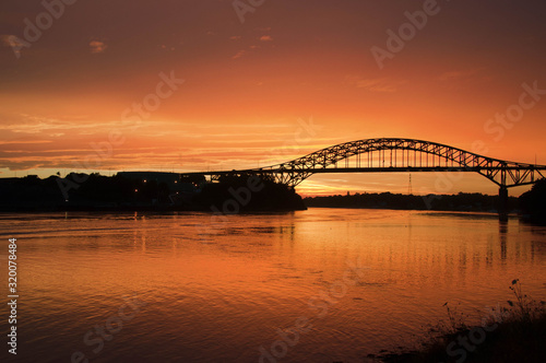 bridge with golden orange sky at sunset
