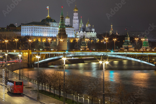 Long exposure photo was taken from the Bol'shoy Kamennyy Most in Moscow. Visible lanmarks: illuminated Kremlin embankment, Armory, Kremlin towers and other beauty in the heart of the Russian capital.
