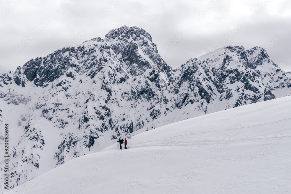 Winter in the mountains and the snowy valleys of the Alps during a fantastic winter day, near the town of Schilpario, Italy - January 2020.