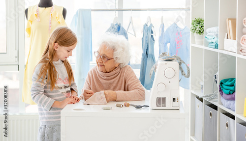 Senior woman instructing little girl