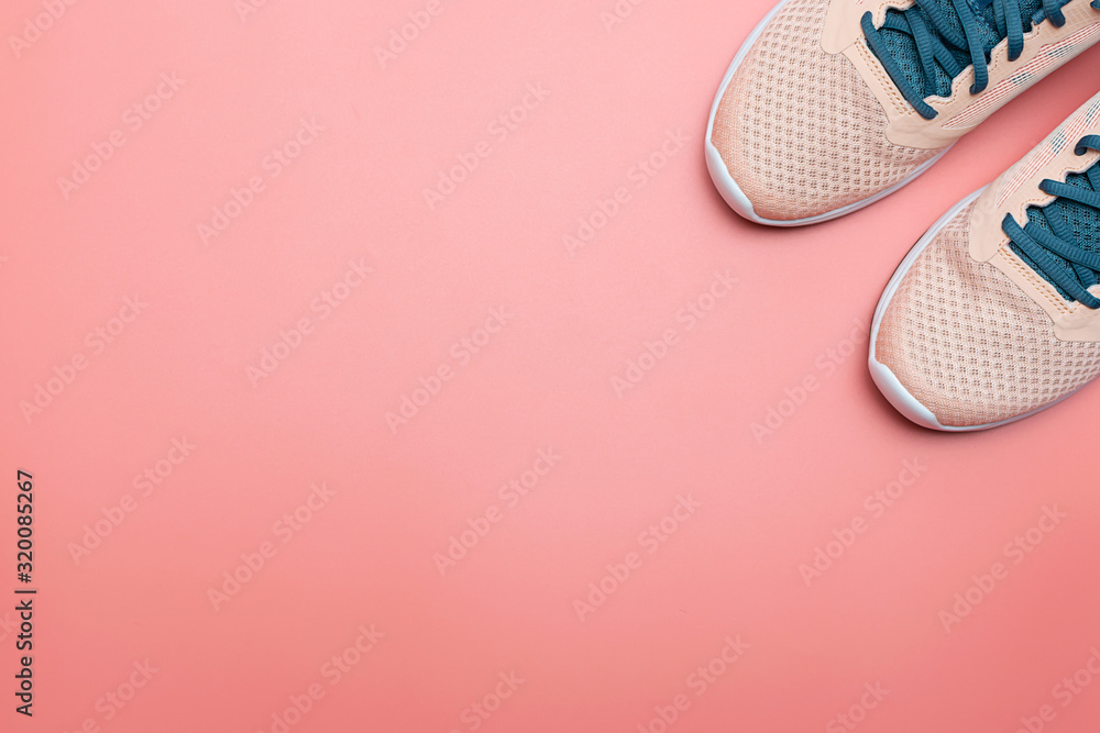 Light pink sneakers on trendy pink background with copy space for your design. Healthy lifestyle and fitness concept. Running shoes on pink background. Minimalism style composition. - obrazy, fototapety, plakaty 