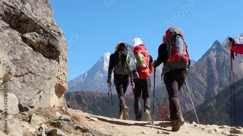 Group of hikers hiking in the mountains alone the trekking road to Everest Base Camp in Nepal