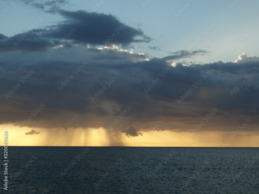 storm clouds at sunset over ocean storm clouds at sunset over ocean