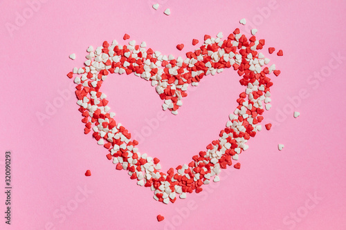 Colorful Valentines Day hearts on pink background