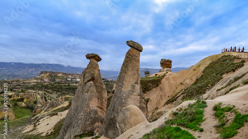 Fabulous landscape with unusual mountain formations. Three Sisters Rocks in Turkish Cappadocia. Panorama with the viewing platform