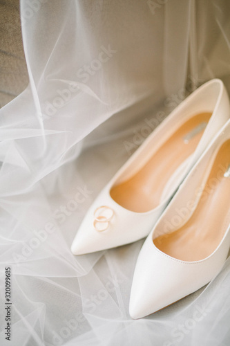 wedding shoes bride and rings on the veil