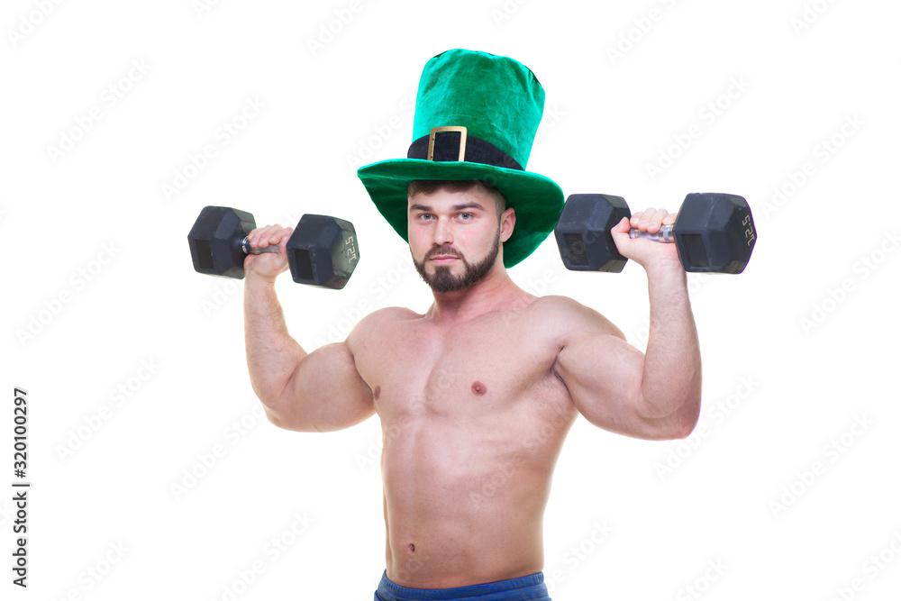 St. Patrick's day. A muscular man in a green hat holds black dumbbells. Isolated white background. ABS.