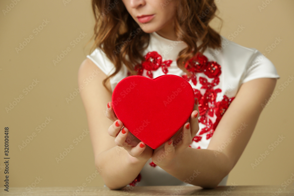 Sad lonely woman holding red heart. Being alone on Valentine's day. Heartbreak, divorce or breakup concept. Sad lonely woman holding red heart. Being alone on Valentine's day. Heartbreak, divorce or breakup concept.