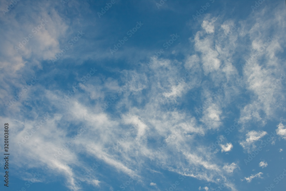 Scattered white clouds on blue sky.