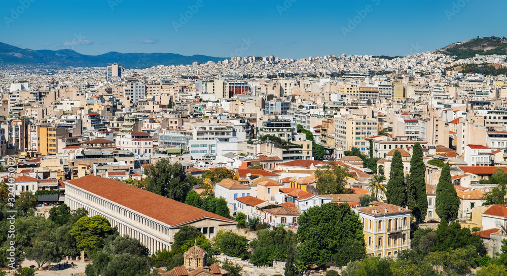 Panorama of Athens as seen from Lycabettus hill, Attica, Greece. Summer scenic cityscape with traditional and modern Greek buildings under blue sky