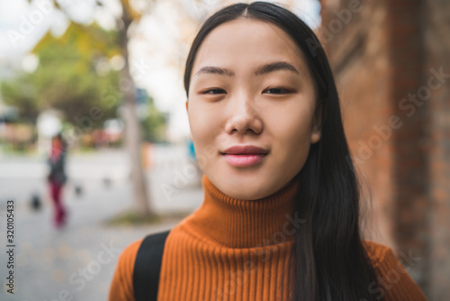Fotografie Portrait of young Asian woman in the street.