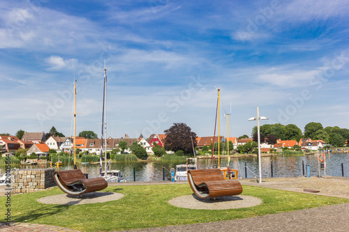 Benches and boats at the harbor of Schleswig, Germany