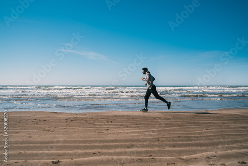 Portrait of an athletic man running.