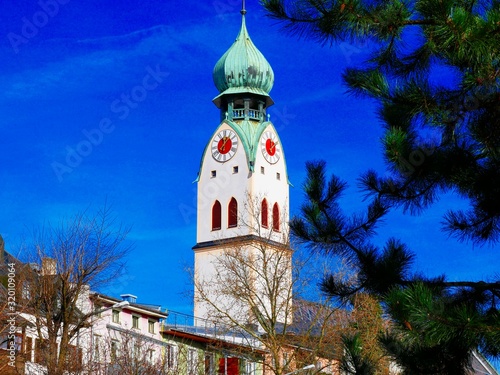 Kirchturm in Rosenheim bei blauem Himmel und Sonnenschein photo