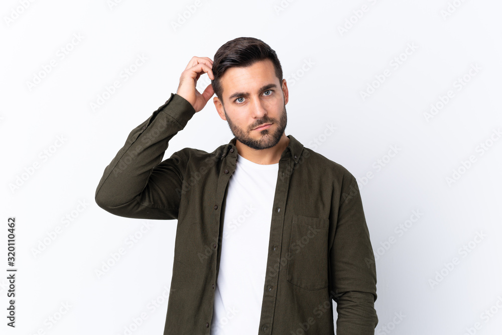 Young handsome man with beard over isolated white background with an expression of frustration and not understanding Young handsome man with beard over isolated white background with an expression of frustration and not understanding