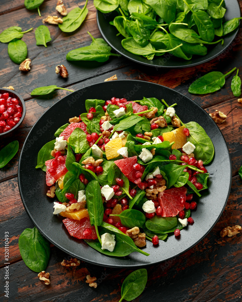Orange Grapefruit salad with spinach, walnuts, pomegranate seeds and feta cheese. healthy food