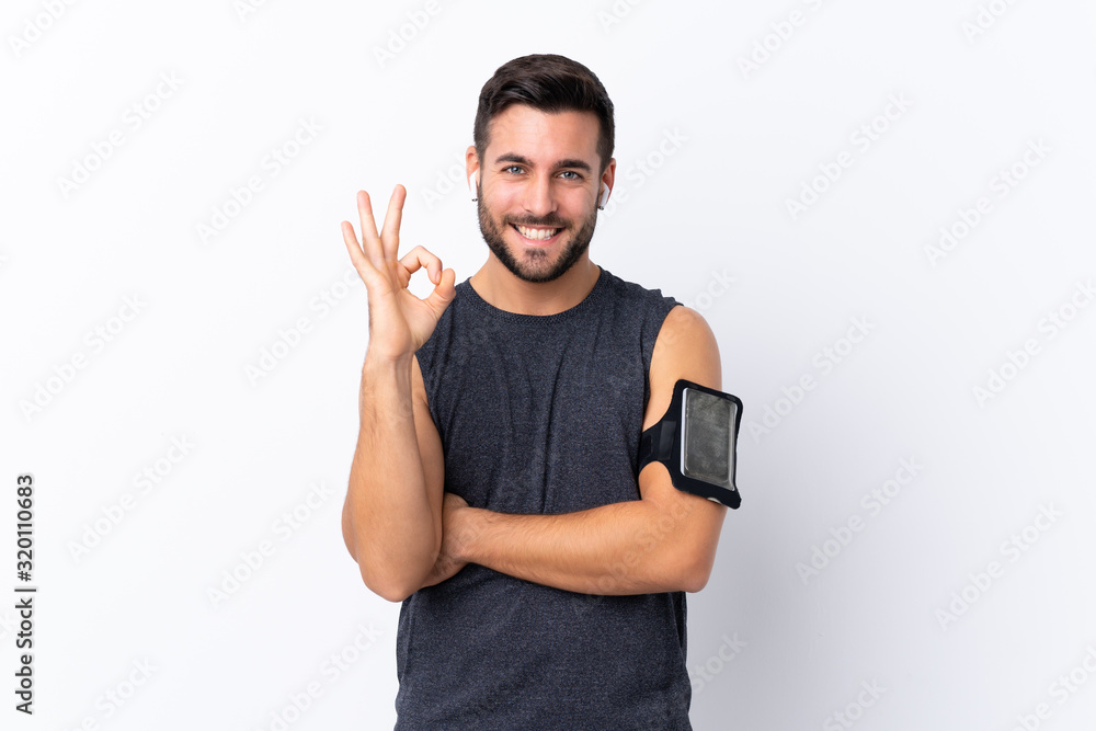 Young sport handsome man with beard over isolated white background showing ok sign with fingers Young sport handsome man with beard over isolated white background showing ok sign with fingers