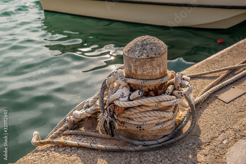 Rope on biteng against the background of water in the port. photo