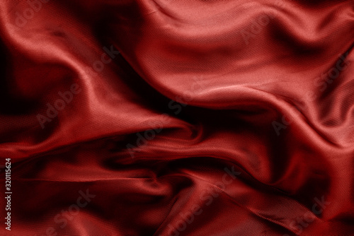 dark red fabric with large folds, textile background