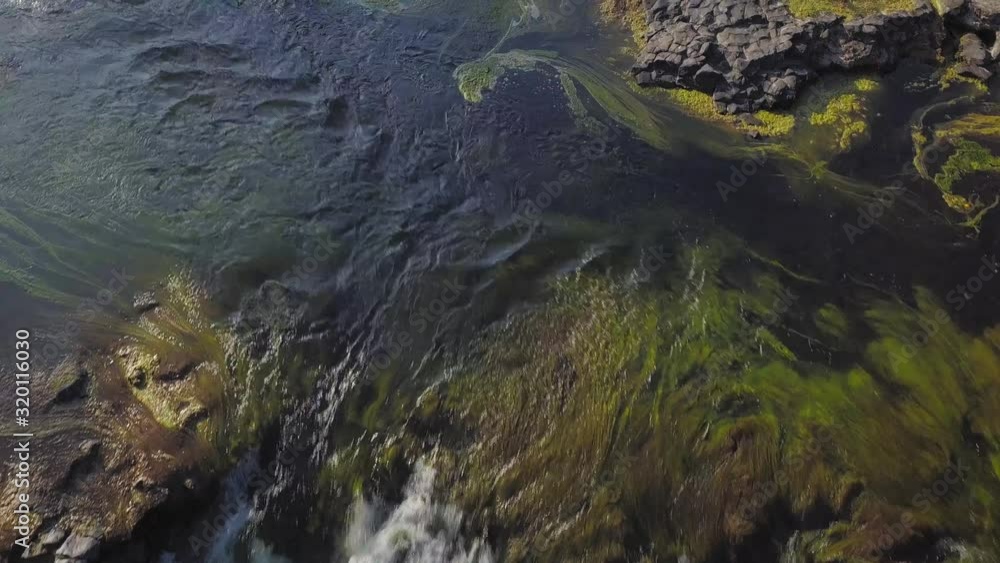 Flyover of the rocks and algae at the top of Haruru Falls in New Zealand Flyover of the rocks and algae at the top of Haruru Falls in New Zealand