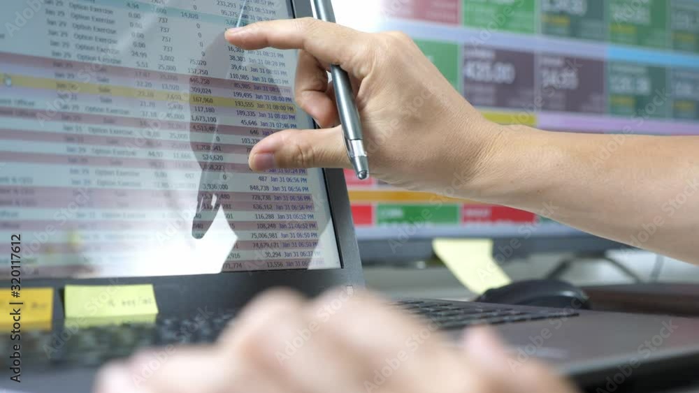 trader use computer explan about forex and cryptocurrency data and bar chart, invester concept. trader use computer explan about forex and cryptocurrency data and bar chart, invester concept.