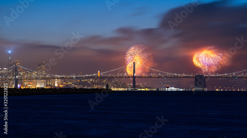 Fourth of July Fireworks Over Bay Bridge and San Francisco Skyline viewed from Alameda Island, California, USA photo