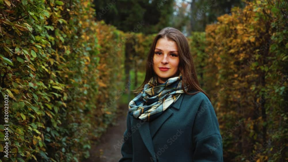Lovely girl posing in garden maze in autumn Lovely girl posing in garden maze in autumn
