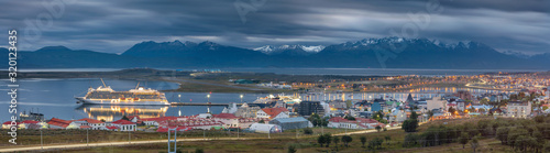 wide panorama of Ushuaia with view to cruise ship in harbor and mountains