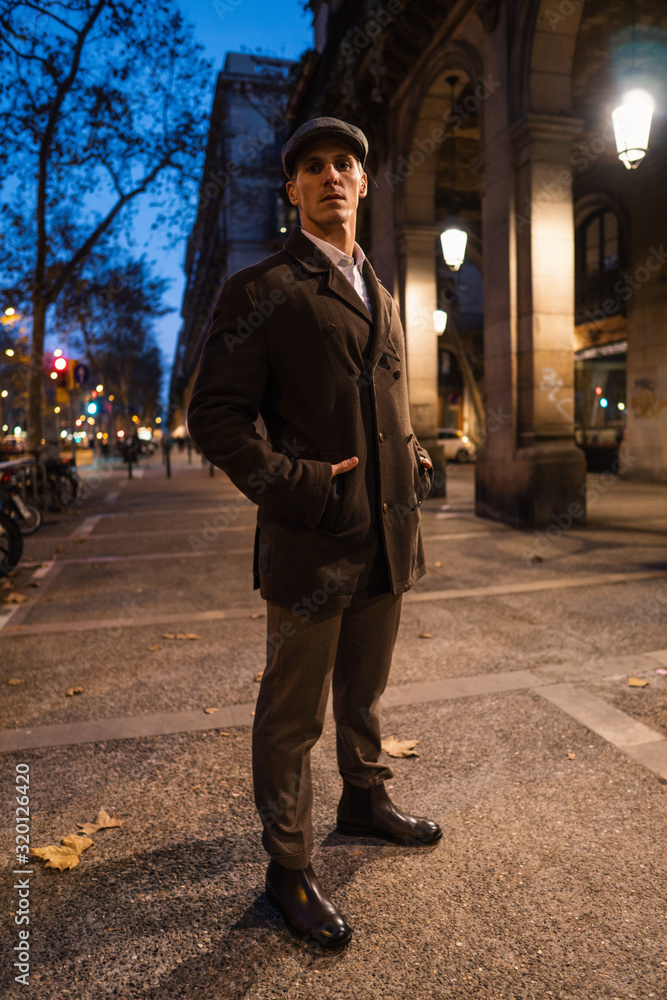 Fototapeta premium Old Fashion Man from the 1920s england walking along an old street of a historic city