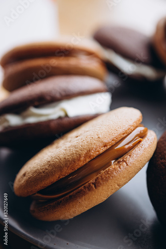 Close up Traditional chocolate and Pumpkin Whoopie pies made with vanilla cream cheese. Background for bakeries, cafes, restaurants