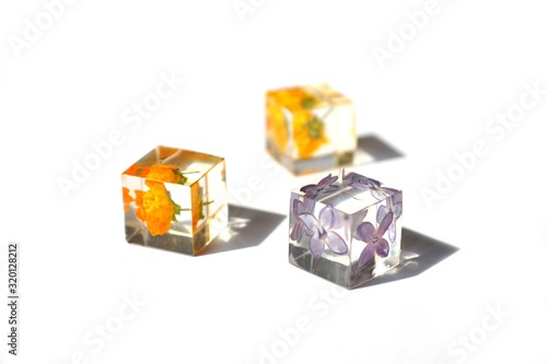 Vector background made transparent cubes with colorful flowers isolated on white background.