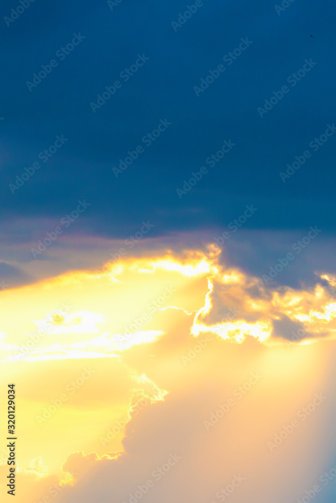 Fototapeta premium Dark stormy sky with the sun translucent