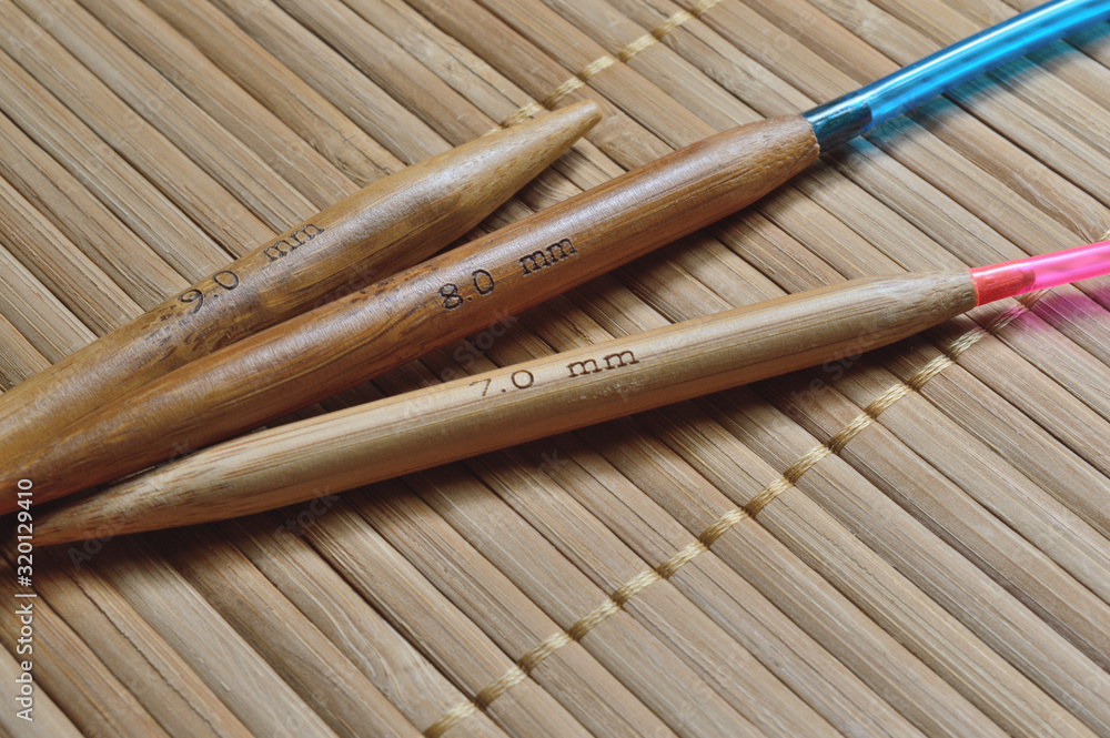 circular bamboo knitting needles on a wooden surface. circular bamboo knitting needles on a wooden surface.