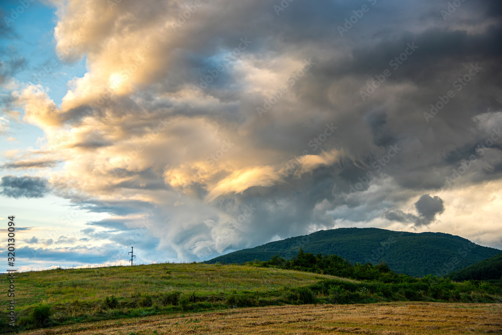 Storm summer clouds in the sunflowers field Storm summer clouds in the sunflowers field