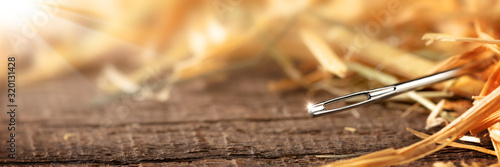 Canvas-taulu Closeup Of A Needle In A Haystack on Wooden Floor With Sunlight - Search Until Y