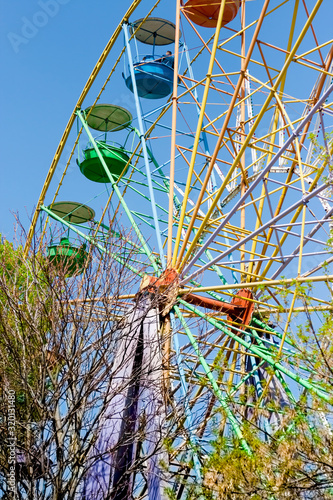 Vintae ferris wheel in high blue sky photo