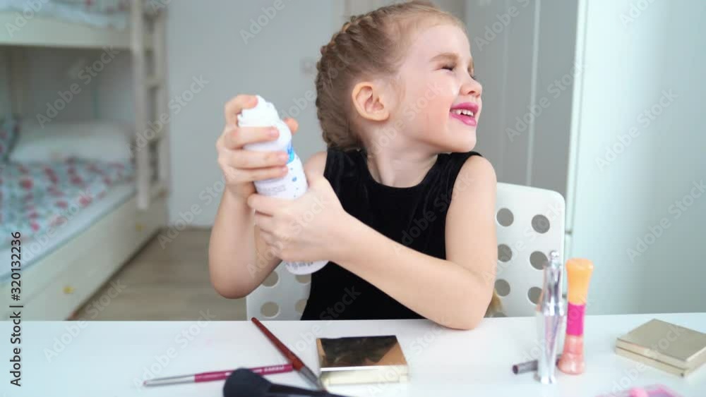 Little girl doing the makeup at home. Beauty blogger. Moisturizes the face. Little girl doing the makeup at home. Beauty blogger. Moisturizes the face.