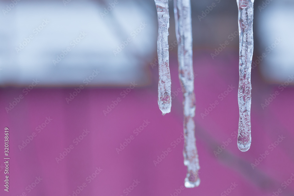 Ice icicles on a blurry background. Ice icicles on a blurry background.