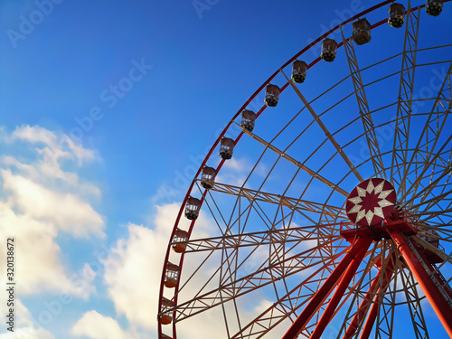 Horizontal image with part of ferris wheel and sky