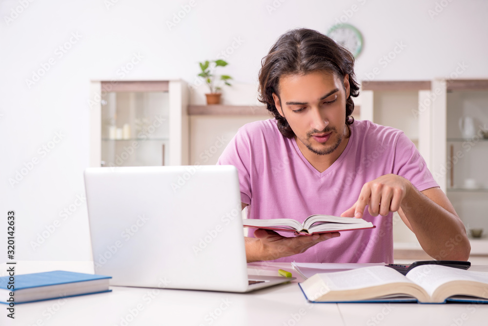 Young male student preparing for exams at home Young male student preparing for exams at home