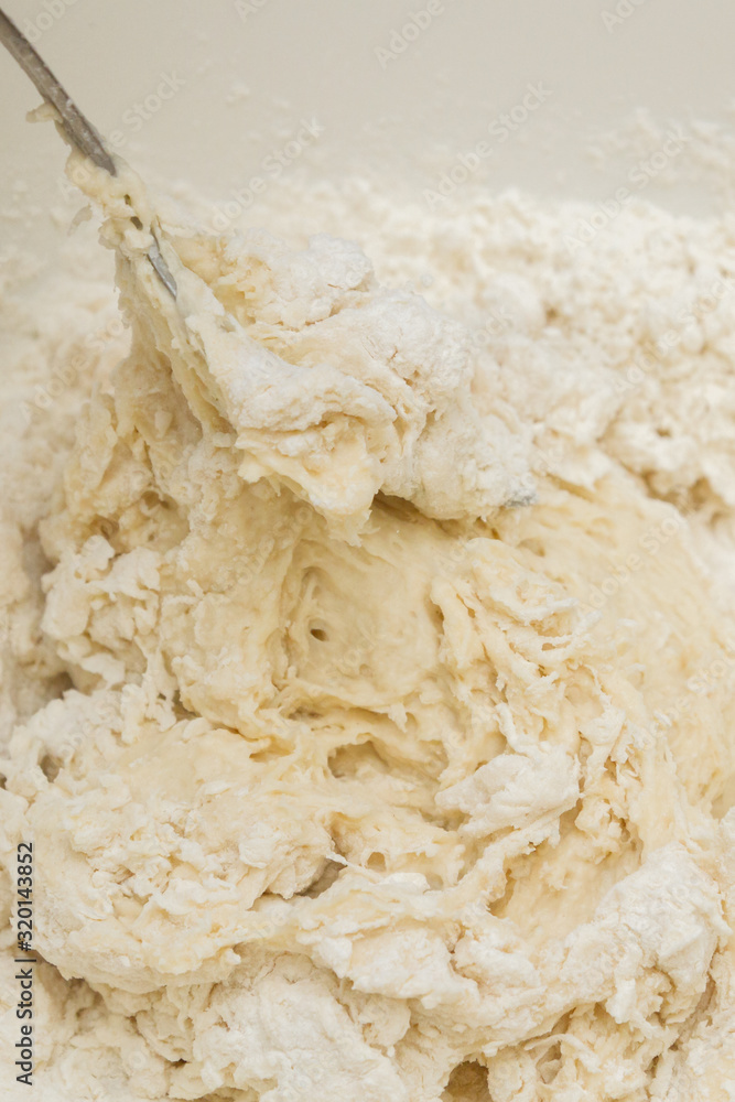 Cooking dough in a white plastic bowl at home Cooking dough in a white plastic bowl at home