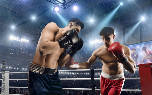 Two boxers are fighting on professional boxing ring. © VIAR PRO studio