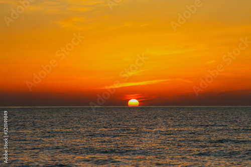 Fototapeta Naklejka Na Ścianę i Meble -  beautiful dawn on the sea, flight of ducks over the sea, ducks fly at dawn over the sea.