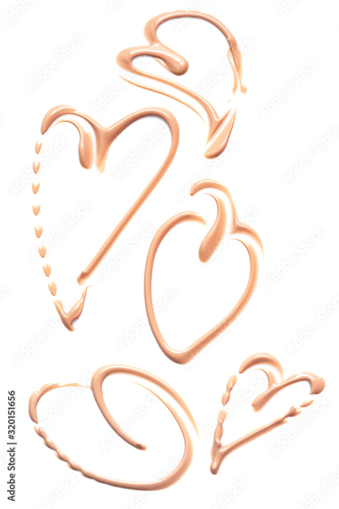 Liquid foundation smears in the shape of a heart isolated on a white background. Cream texture for makeup. Liquid foundation smears in the shape of a heart isolated on a white background. Cream texture for makeup.