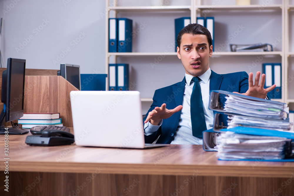 Young handsome businessman working in the office Young handsome businessman working in the office