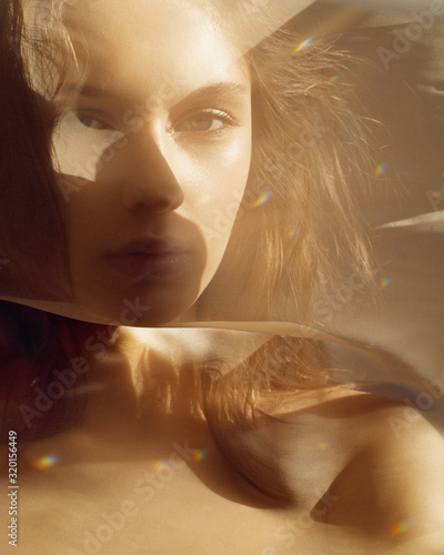  Oriental portrait in the rays of the setting sun through the veil