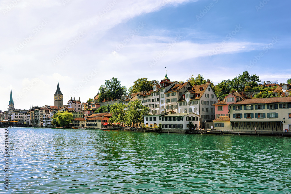 Limmat River quay and St Peter Church and Fraumunster Church in the city center of Zurich, Switzerland.