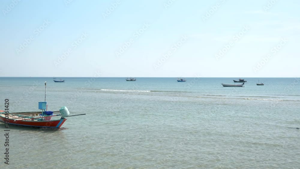 Traditional fishing boats anchoring in the shallow harbor. Traditional fishing boats anchoring in the shallow harbor.